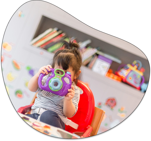 Child holding a toy camera